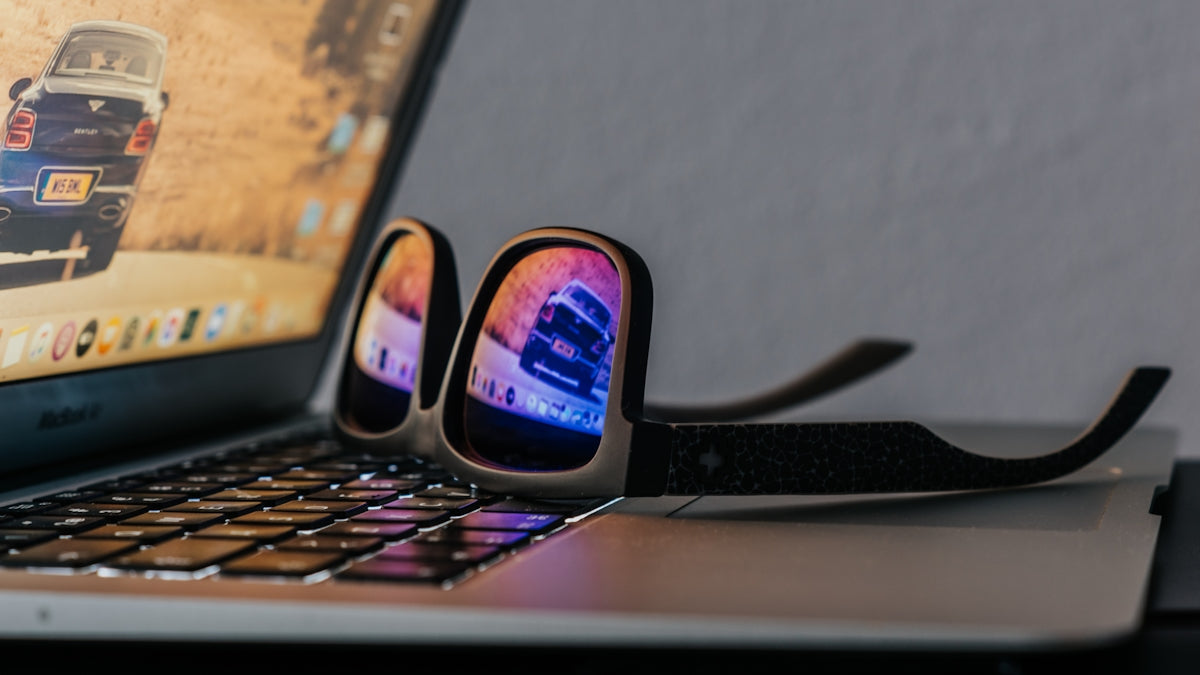 black smartphone on black laptop computer