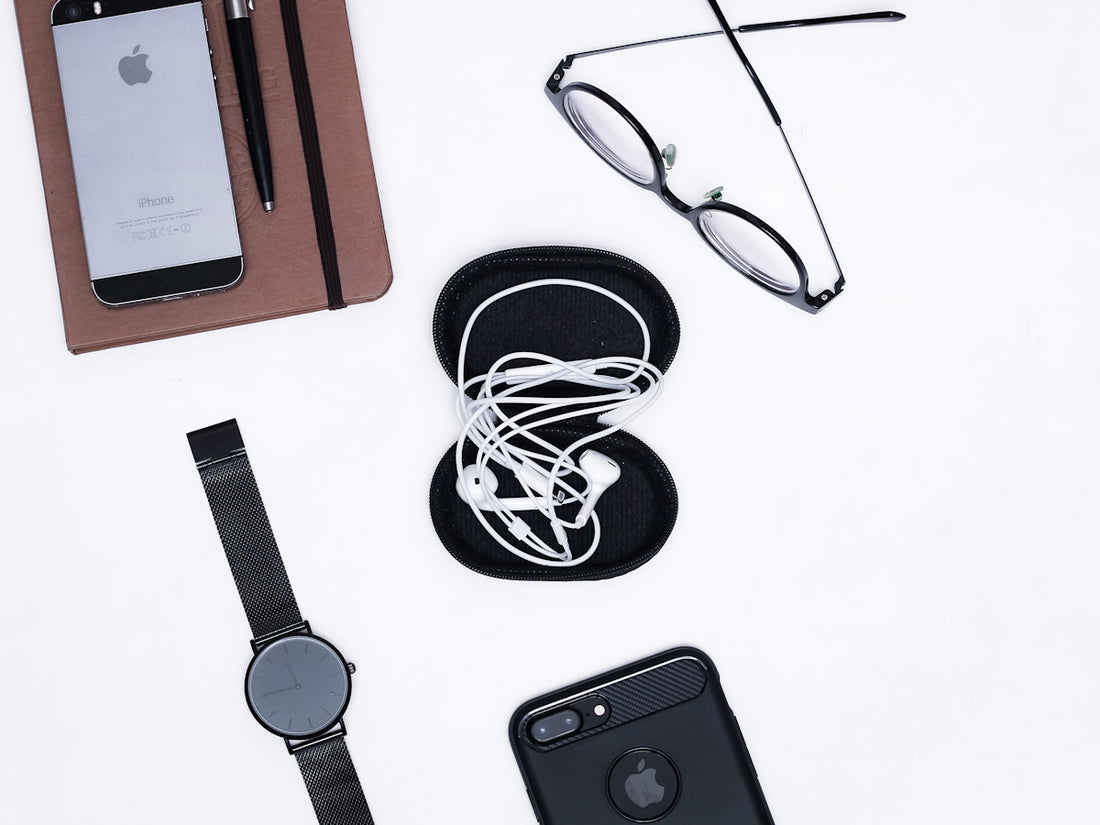 black iphone 4 beside black framed eyeglasses and black iphone 4