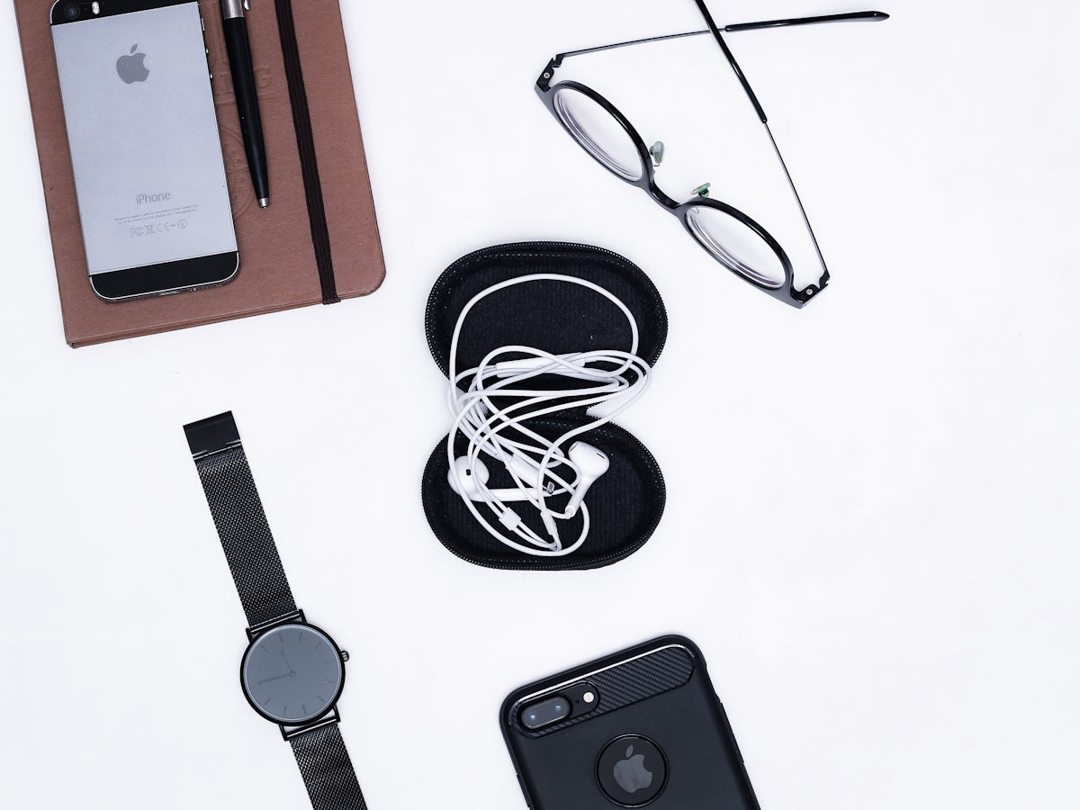 black iphone 4 beside black framed eyeglasses and black iphone 4