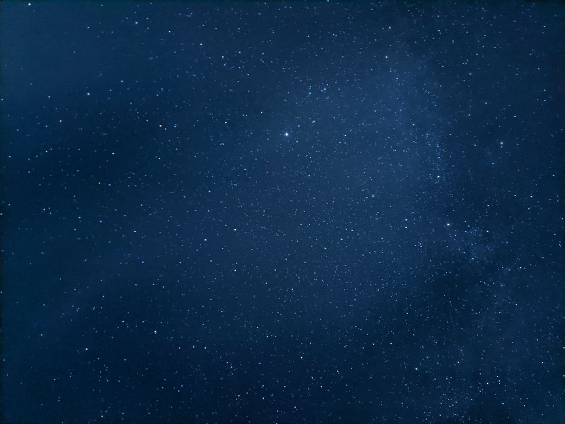 a night sky with stars and a few clouds