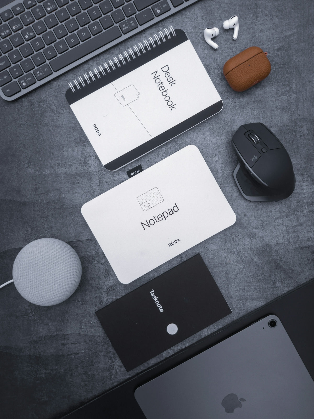 a desk with a keyboard, mouse, mouse pad and other items