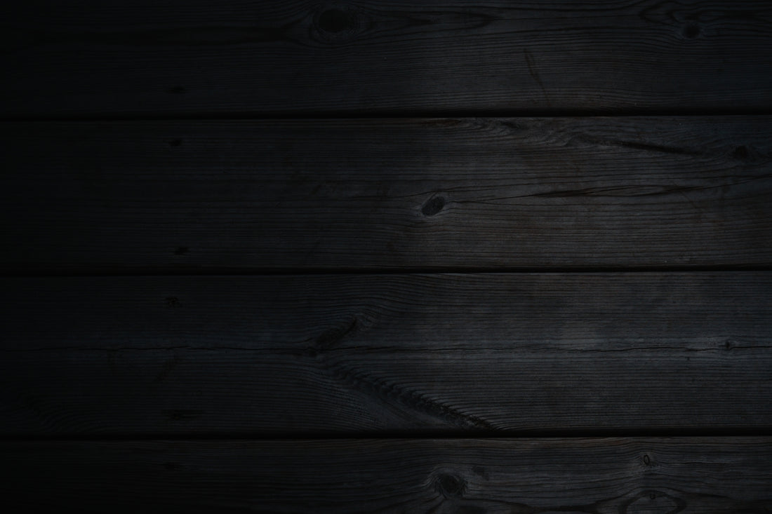 a dark wood background with a black background