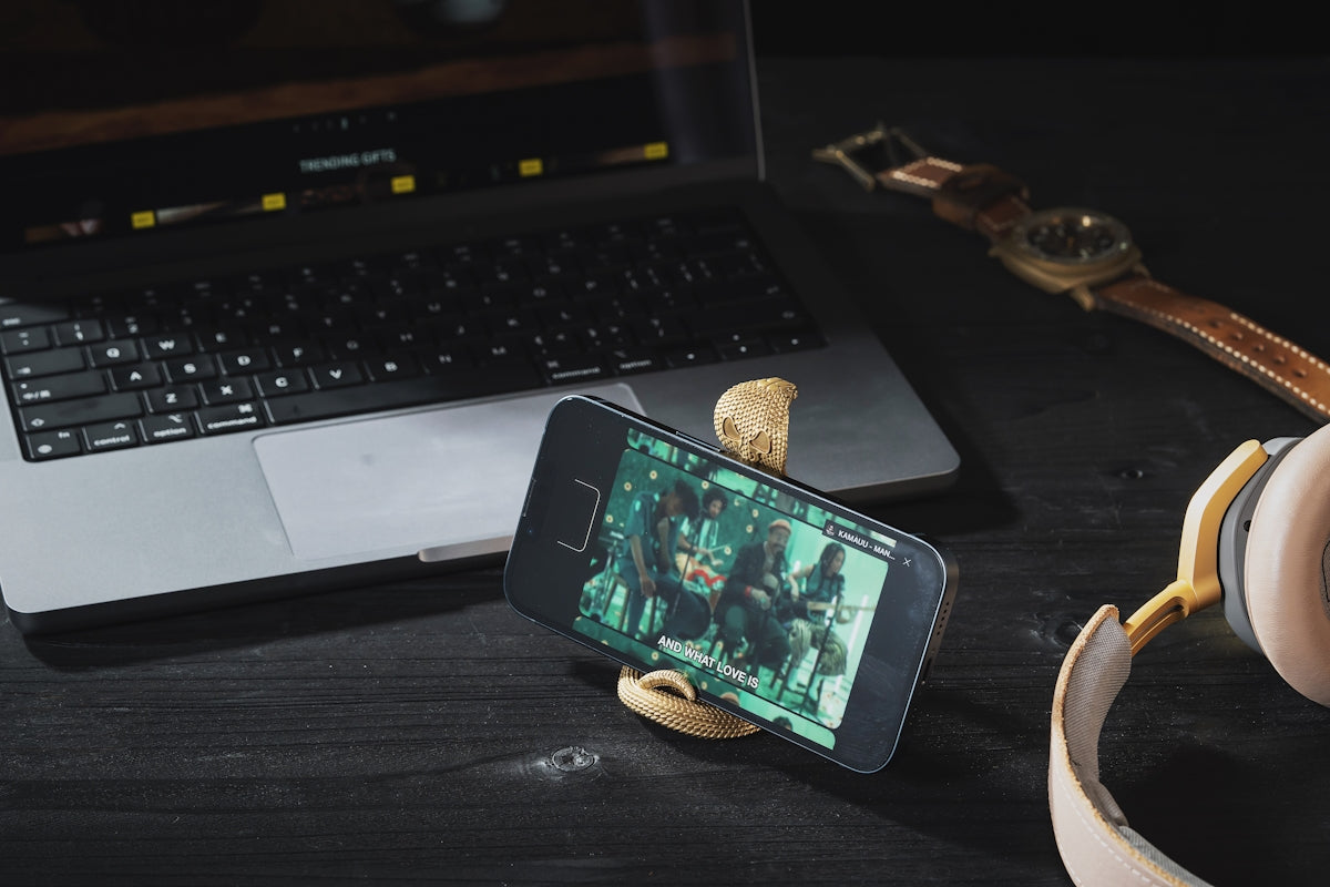 a cell phone and headphones on a desk
