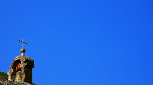 A church steeple with a cross on top