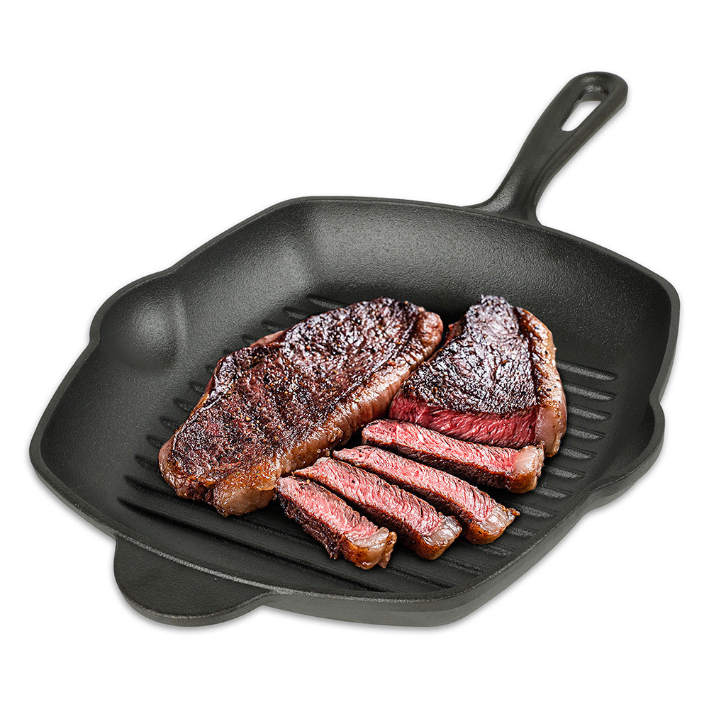Sartén grill cuadrado de hierro fundido negro con mango y cortes de carne asada